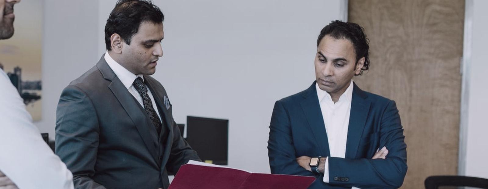 Two professionals reviewing a file together