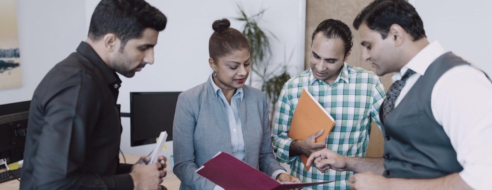 A team discussing documents in an office