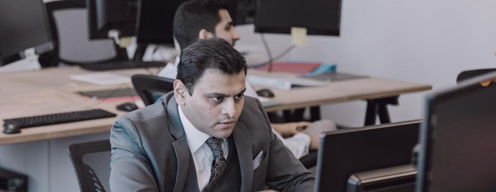 A professional at his desk in an Indian office